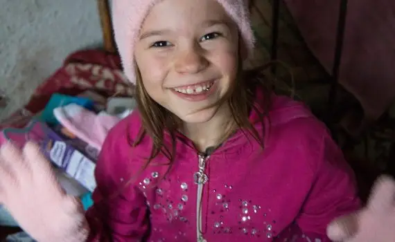 Girl wearing new hat and gloves